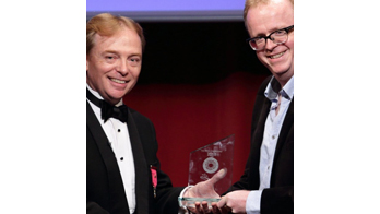 NOEL QUALTER receiving an award from the President of the Magic Circle Scott Penrose